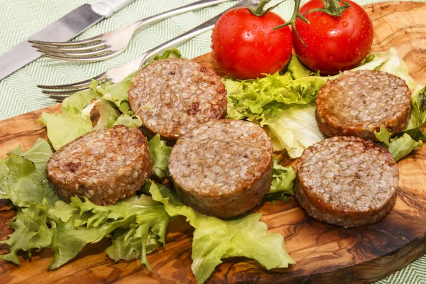 Grilled irish white pudding made with oatmeal on a wooden board — Stock Photo, Image