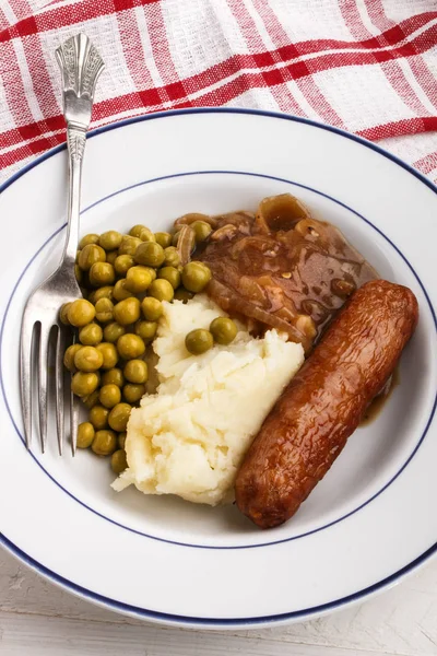 BANGER a mash brambor s vařené hrachu — Stock fotografie