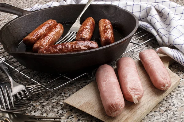 Raw and fried irish pork sausages — Stock Photo, Image