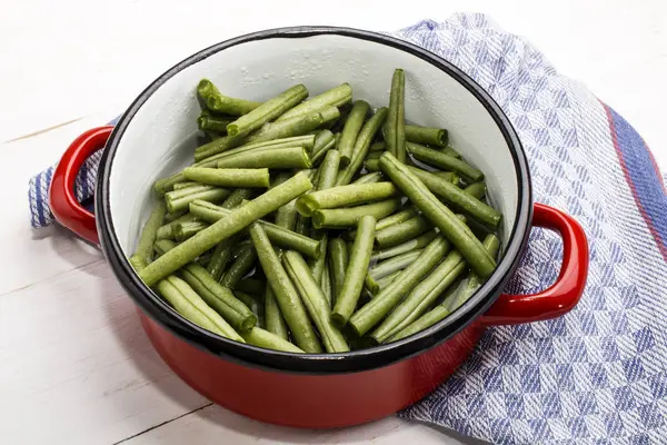 Green beans in a water filled enamel pot — Stock Photo, Image