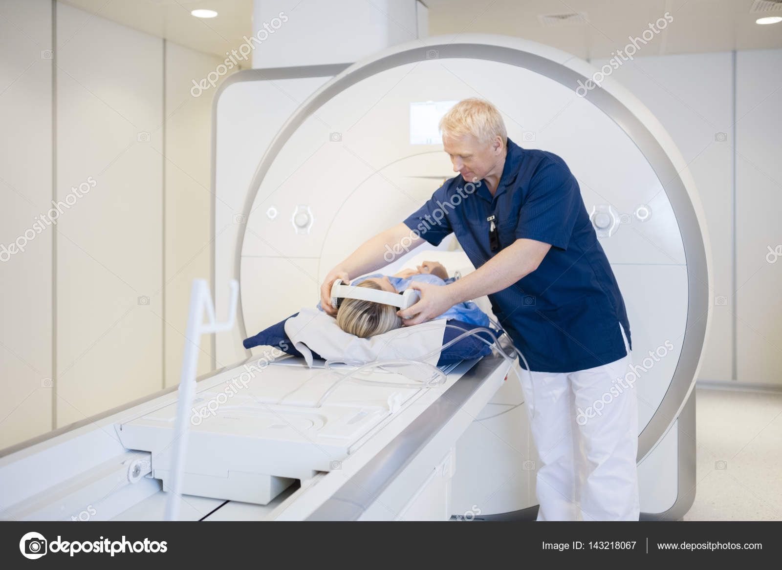 Radiologist Putting Headphones On Patient Undergoing MRI Scan — Stock