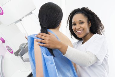 Happy Doctor Assisting Patient Undergoing Mammogram X-ray Test clipart