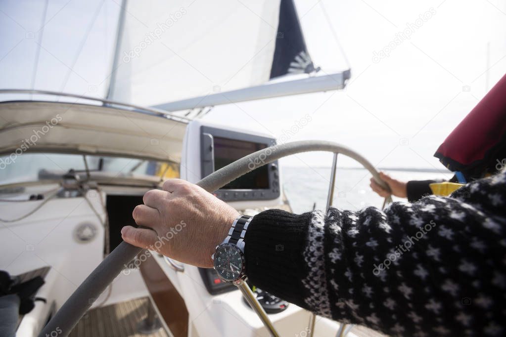 Mans Hands Steering Wheel Of Yacht