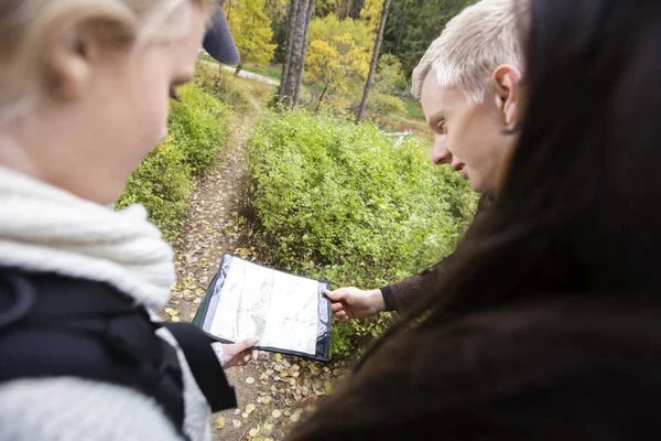 Friends Holding Map While Hiking In Forest — Stock Photo, Image