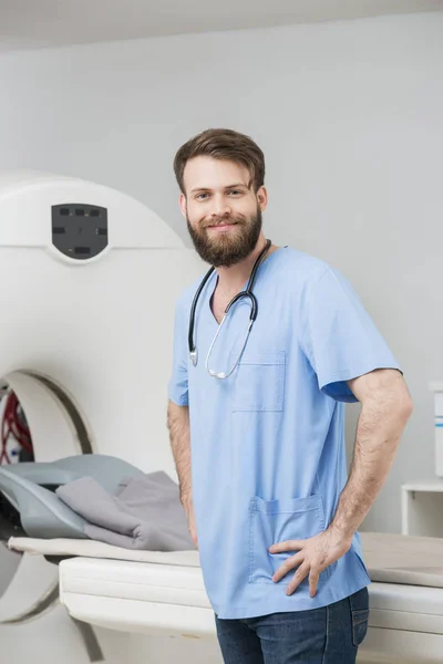 Radiologista confiante em pé pelo tomógrafo no hospital — Fotografia de Stock