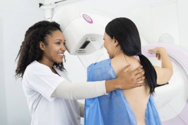 Happy Doctor Assisting Woman Undergoing Mammogram X-ray Test clipart