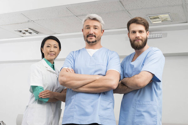 Portrait Of Confident Doctors Standing Arms Crossed