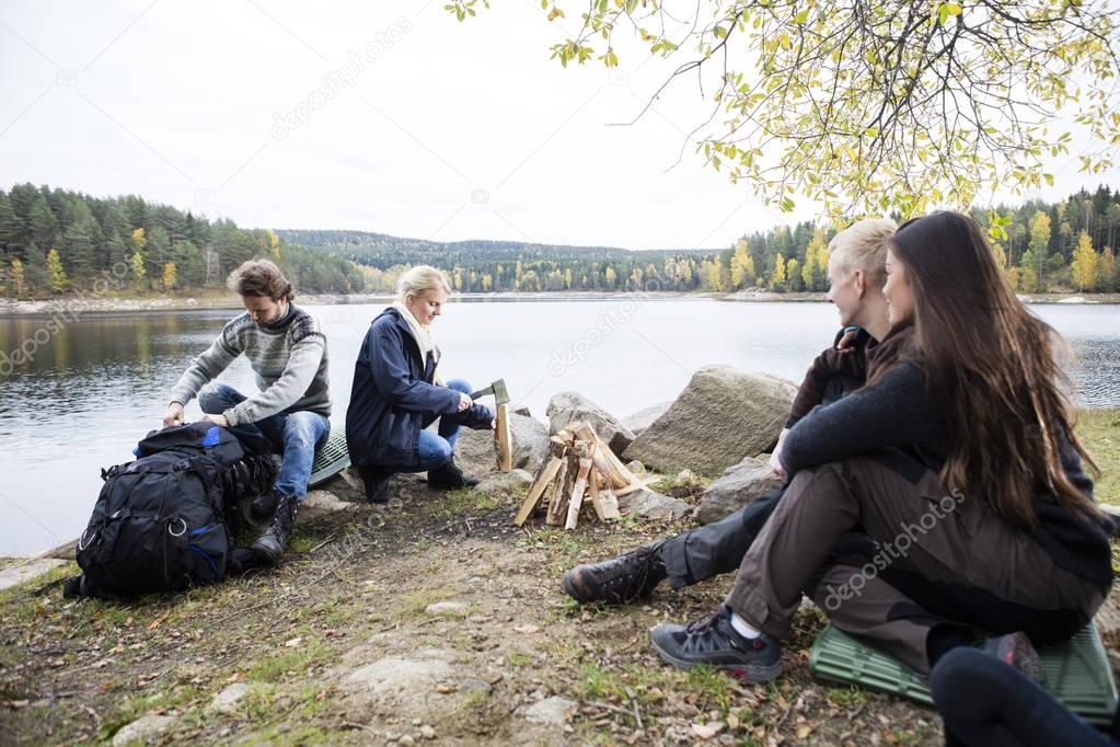 Friends Preparing For Camping On Lakeshore