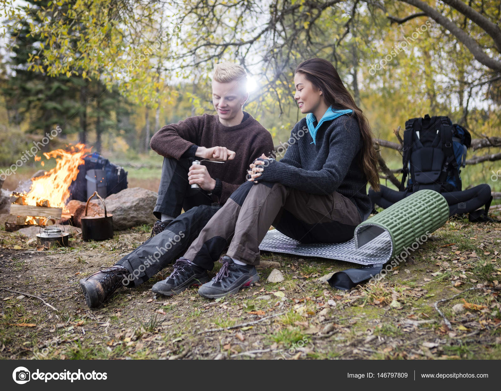 Woman With Man Grinding Coffee During Camping In Forest - Stock Photo, Imag...