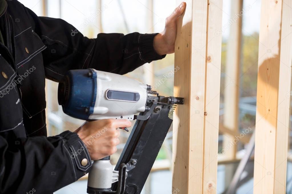 Cropped Image Of Male Carpenter Drilling Wood