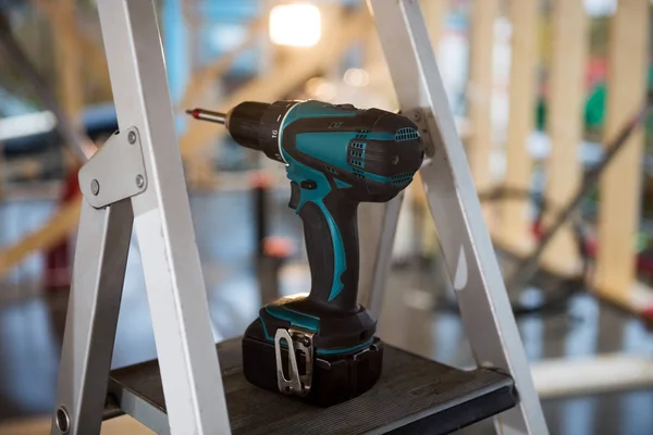 Portable Hand Drill On Ladder At Site — Stock Photo, Image