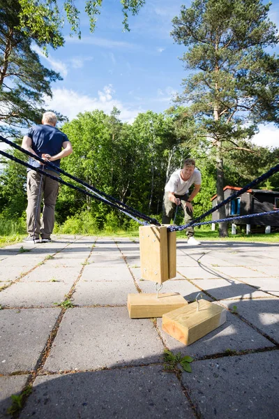 Happy Man Picking Wooden Blocks By Friend On Patio — Stock Photo, Image