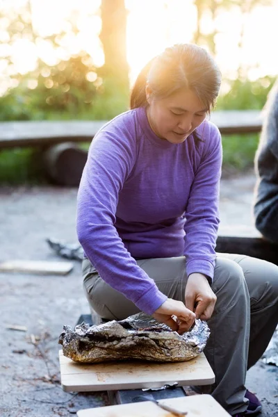 Businesswoman Eating Food In Foil While Sitting On Bench — Stock Photo, Image