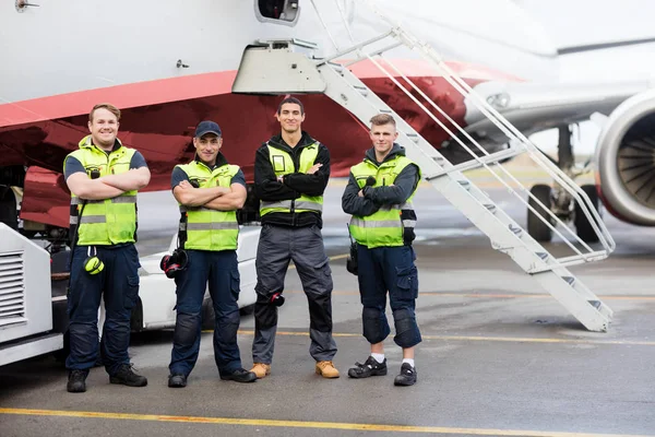 Portrait Of Ground Team Standing Arms Crossed Against Airplane — Stock Photo, Image