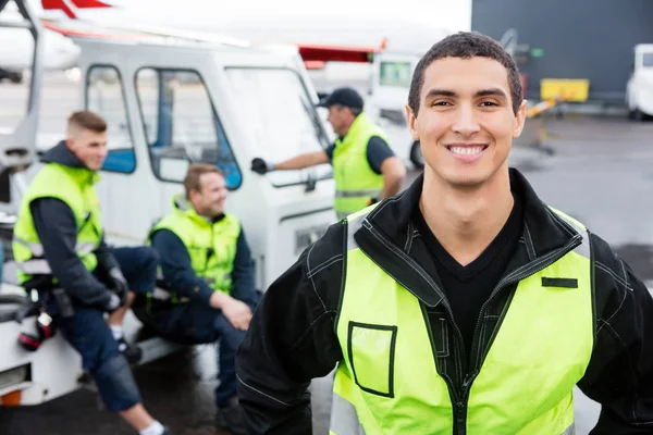 Confident Worker Smiling While Colleagues Communicating At Gangw — Stock Photo, Image