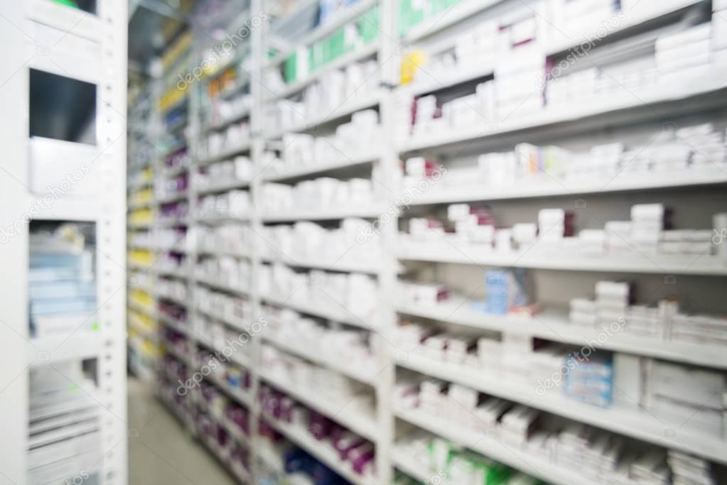 Defocused Image Of Packed Medicines Arranged In Shelves