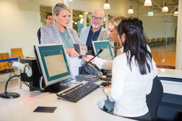 Serious Businesswoman Showing Passport To Staff At Airport — Stock Photo, Image