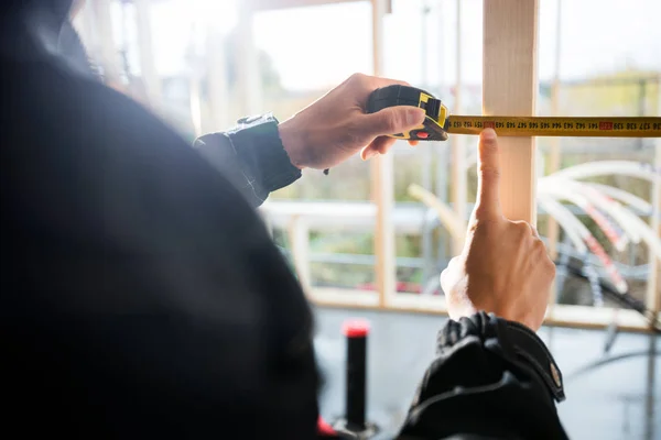 Carpenters Hand Touching Number On Tape Measure At Site — Stock Photo, Image