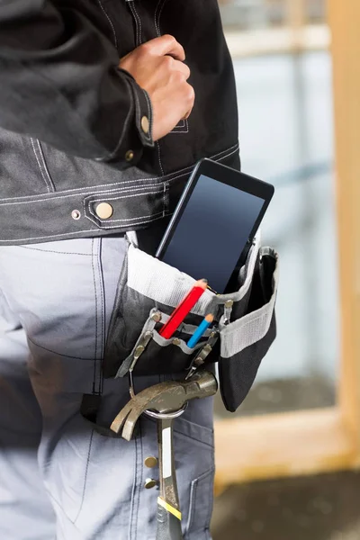 Carpenter With Tablet Computer And Tools In Bag At Site — Stock Photo, Image