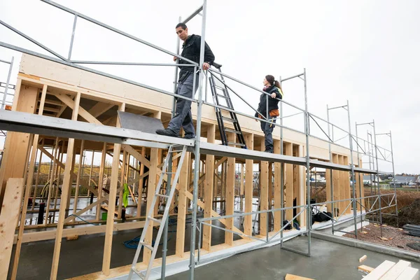 Colleagues Walking On Scaffolding At Construction Site — Stock Photo, Image