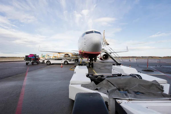 Camion di traino con aereo commerciale sulla pista dell'aeroporto — Foto Stock