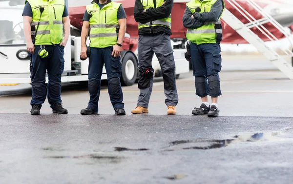 Low Section Of Ground Crew Standing On Runway — Stock Photo, Image