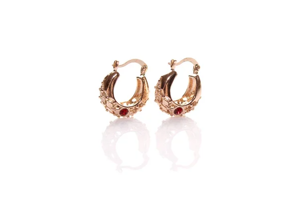 Gold earrings with red gem. Isolated — Stock Photo, Image