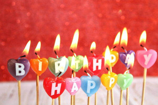 Multi-colored candles with texts Happy Birthday