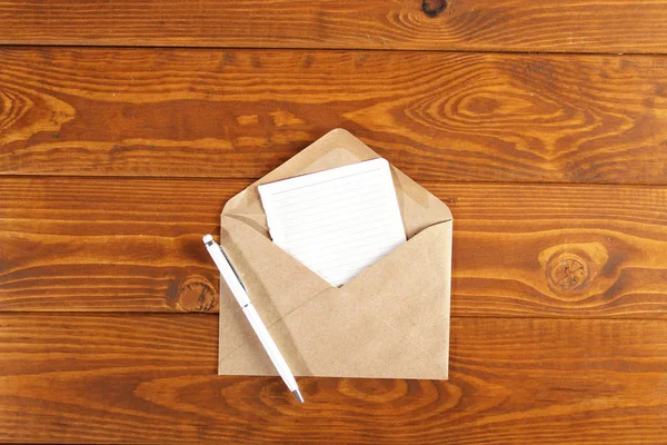 Cuaderno con pluma sobre una mesa de madera — Foto de Stock