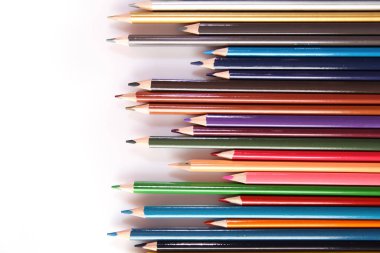 Colored pencils lie in a row