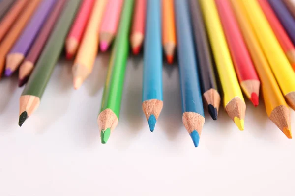 Colored pencils lie in a row — Stock Photo, Image