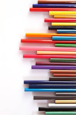 Colored pencils lie in a row