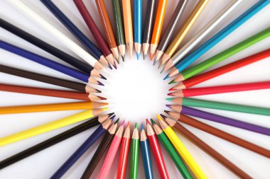 Colored pencils lie in a row