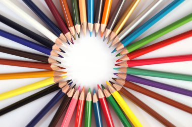 Colored pencils lie in a row