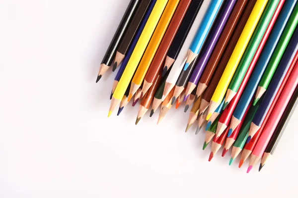 Colored pencils lie in a row — 图库照片
