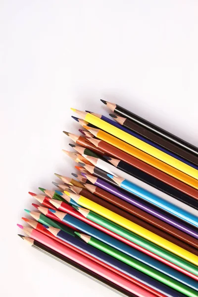 Colored pencils lie in a row — 스톡 사진