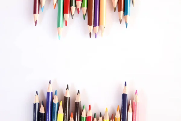 Colored pencils lie in a row — 스톡 사진