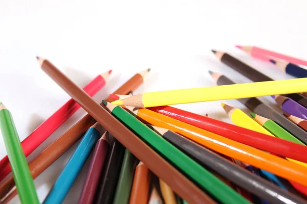 Colored pencils lie in a row — Stockfoto