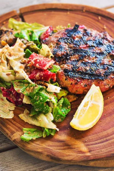 Low carb (bunless) burger served on a rustic wooden board with salad, selective focus — Stock Photo, Image