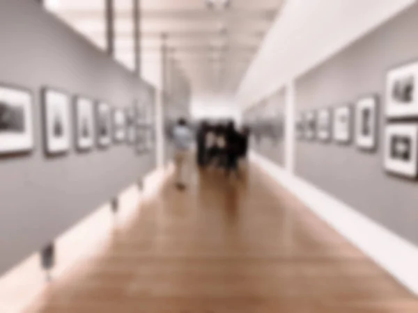 People in art gallery with blurred effect on the photo. — Stock Photo, Image