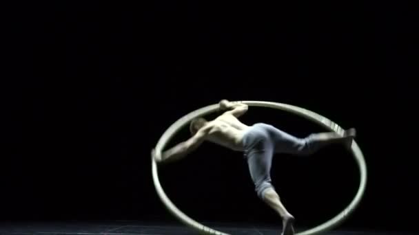 Muscular circus artist in the Cyr Wheel doing difficult tricks slow motion. Concept of concentration and balance — 비디오