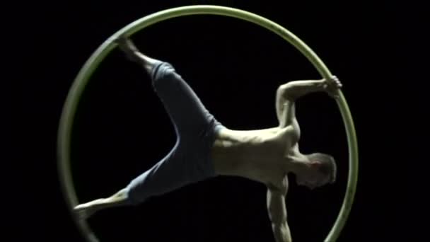 Muscular circus artist in the Cyr Wheel doing difficult tricks slow motion. Concept of concentration and balance — 비디오