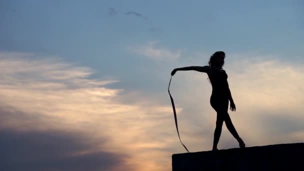 Professional gymnast woman dancer with ribbon on sky background — Stock Video