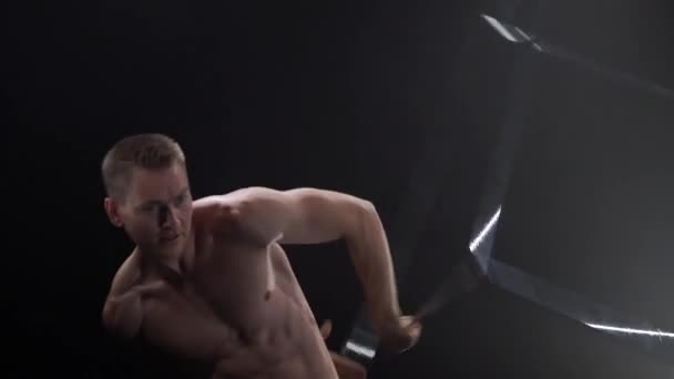 Circus male muscular performer making tricks with juggling cube props at black background. Concept of concentration, control, force and power — Stock Video