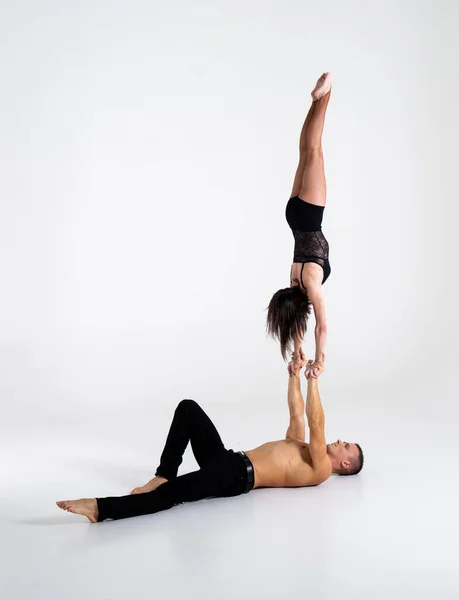 Duo Of Acrobats Showing hand to hand Trick, Isolated On White