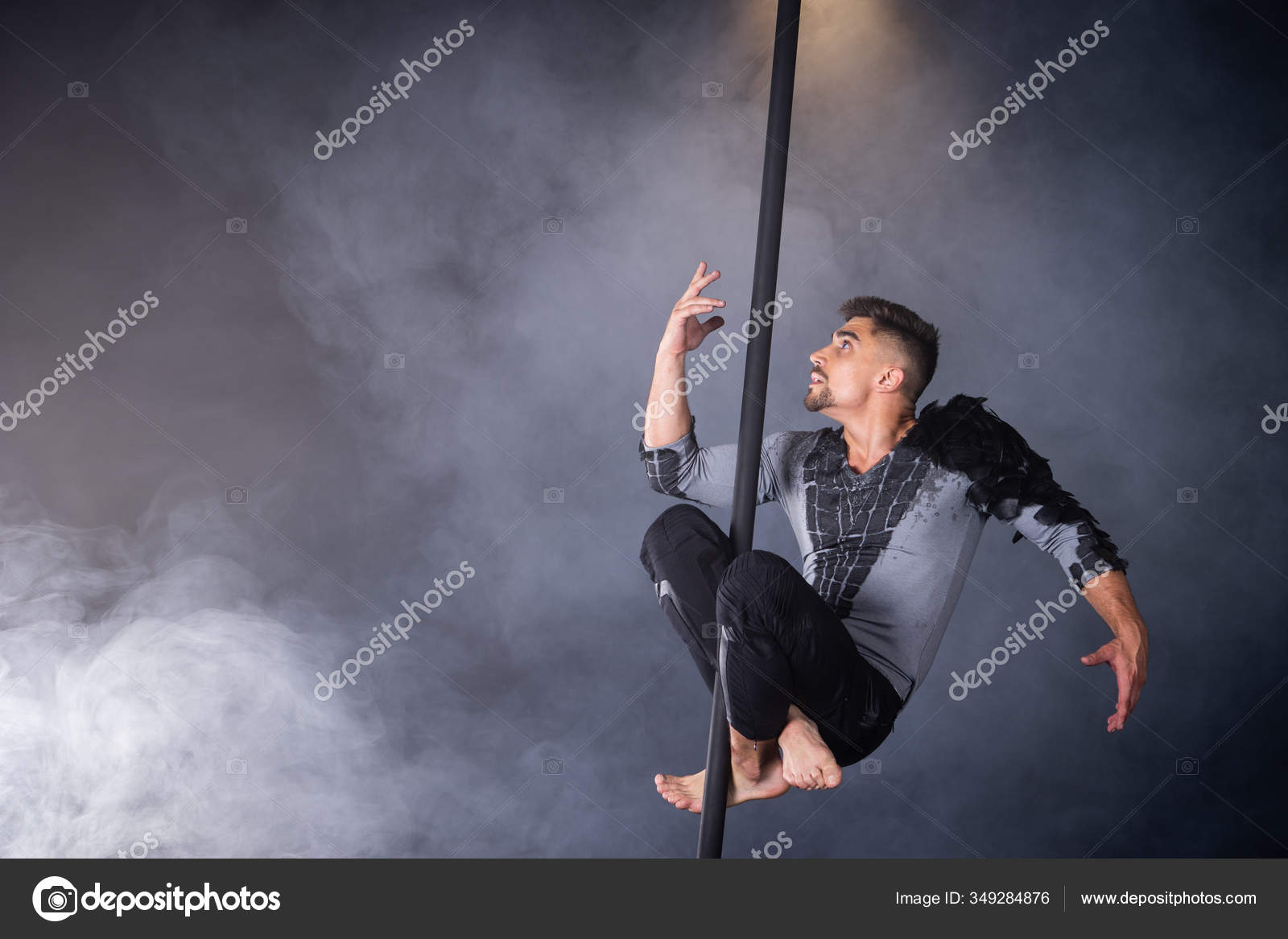 Performance concept. Man hanging on chinese pole. Athlete