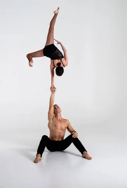 Duo Of Acrobats Showing hand to hand Trick, Isolated On White