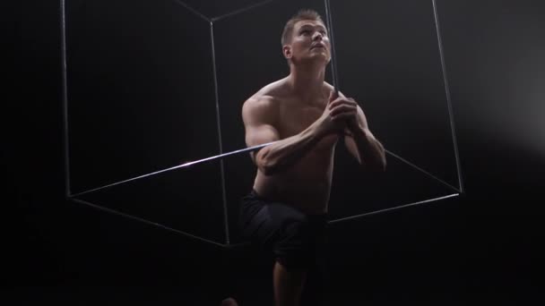 Circus male muscular performer making tricks with juggling cube props at black background. Concept of concentration, control, force and power — Stock Video