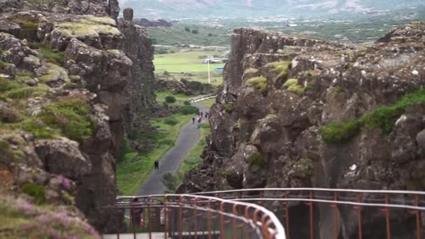 Lower trail sandwiched between the broken-apart cliffs at Thingvellir national park — Stock Video