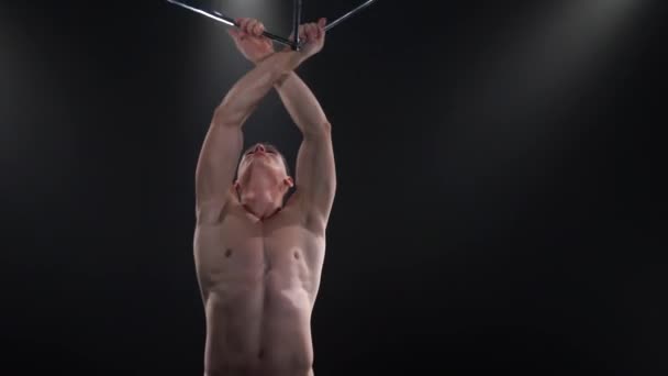 Circus male muscular performer making tricks with juggling cube props at black background. Concept of concentration, control, force and power — Stock Video